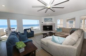 a living room with a couch and a fireplace at Sunset On The Strand in Oceanside