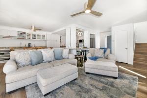 a living room with a couch and two chairs at Pacifica Strand Unit 15 in Oceanside