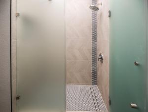 a shower with a glass door in a bathroom at Pacifica Strand Unit 15 in Oceanside +51 photos