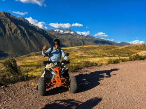 a man on a four wheeler on a dirt road at Chaska Valle Green in Urubamba