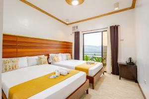 a bedroom with two beds and a large window at Mabini Sky View in Cebu City +45 photos