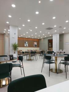 a waiting room with tables and chairs in a building at Daejeon Continew Hotel in Daejeon