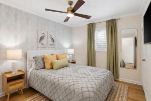 a bedroom with a bed and a ceiling fan at Sunwashed Stone Villa with Heated Pool, Hot Tub & Mini Golf in Bradenton