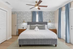 a bedroom with a bed with a ceiling fan at Sunwashed Stone Villa with Heated Pool, Hot Tub & Mini Golf in Bradenton