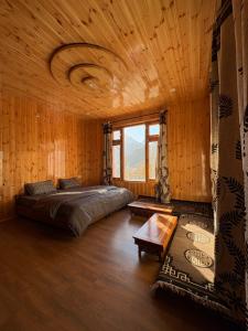 a bedroom with a bed in a wooden room at Shubham homestay in Sissu