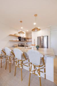 a kitchen with a table and chairs in a kitchen at B304 - The Lookout in Oceanside