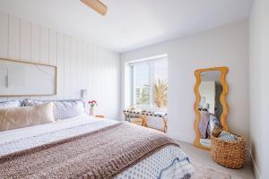 a bedroom with a bed and a large mirror at B304 - The Lookout in Oceanside +94 photos