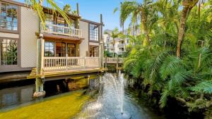a house with a fountain in the middle of a pond at B304 - The Lookout in Oceanside