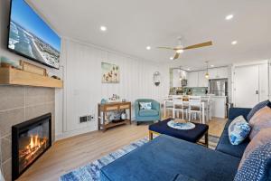 a living room with a couch and a fireplace at B302 - Barefoot Villa in Oceanside
