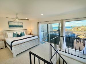 a bedroom with a bed and a balcony with a view at B302 - Barefoot Villa in Oceanside +62 photos