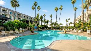 a swimming pool at a resort with palm trees at B302 - Barefoot Villa in Oceanside