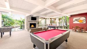 a pool table in a room with a fireplace at B302 - Barefoot Villa in Oceanside