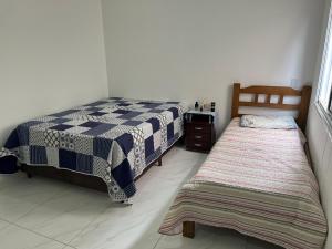 a bedroom with two beds in a room at Casa Sonho Meu in Joanópolis