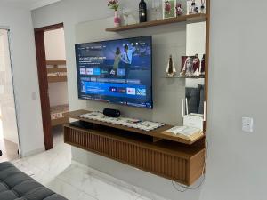 a living room with a large flat screen tv at Casa Sonho Meu in Joanópolis