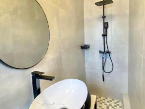 a bathroom with a toilet and a mirror at MRF Lodge in Louis Trichardt +8 photos