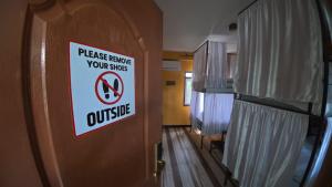 a sign on a door that reads please refuse your slavesulse at Kiwi Backpackers Hostel Pokhara in Pokhara +96 photos