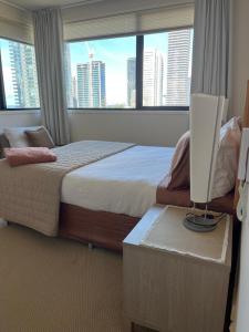 a hotel room with a bed and a large window at Broadbeach on the Park in Gold Coast +14 photos
