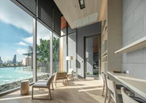 an open living room with a view of the water at Oakwood Suites Bangkok in Bangkok