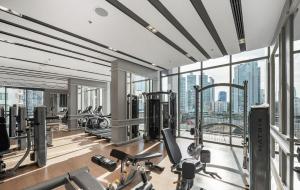 a gym with treadmills and exercise equipment in a building at Oakwood Suites Bangkok in Bangkok