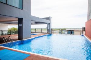 a swimming pool on the roof of a building at The MAJULAN Hotel in Kota Kinabalu