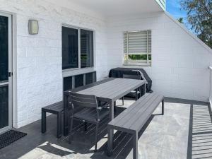 a wooden table and chairs on a patio at Arcadia Beach Unit 3 in Arcadia