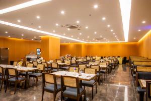 a dining room filled with tables and chairs at The MAJULAN Hotel in Kota Kinabalu