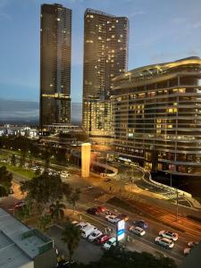 a city skyline with tall buildings and cars in traffic at Broadbeach on the Park in Gold Coast