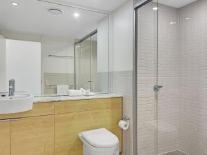 a bathroom with a toilet and a sink and a shower at Blue on Blue Studio Room 1352 in Nelly Bay