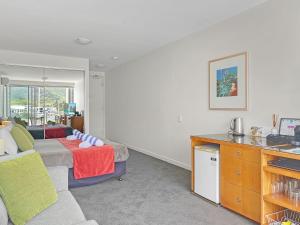 a living room with a couch and a table at Blue on Blue Studio Room 1352 in Nelly Bay