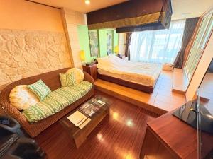 a living room with a bed and a couch at avilla RESORT in Iwaki