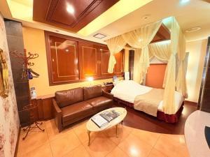 a hotel room with a bed and a couch at avilla RESORT in Iwaki