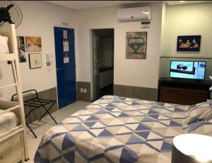 a bedroom with a bed and a television in it at iHostel Aldeota in Fortaleza
