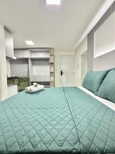 a large bedroom with a large green bed at Compacto Flat na Orla de Intermares in Cabedelo