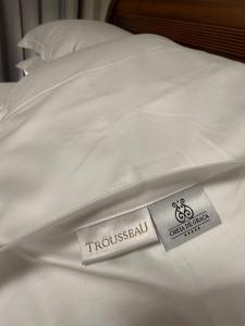 a white comforter with a hospital tag on a bed at Suite Boutique 102 Cheia de Graça in Divinópolis