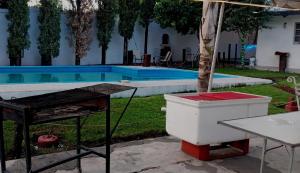 a ping pong table next to a swimming pool at Bolet in Monterrey