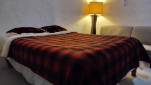 a bedroom with a bed with a blanket on it at Bolet in Monterrey