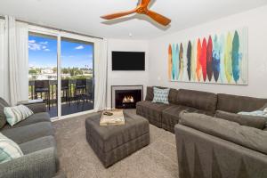 a living room with a couch and a fireplace at B306 - Endless Summer in Oceanside