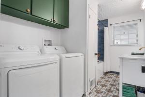 a white laundry room with a washer and dryer at Nueces River Escape in Uvalde +34 photos