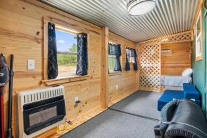 a small cabin with a tv and a bed in it at Nueces River Escape in Uvalde