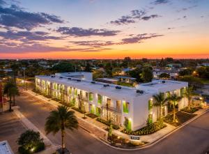 a large white building with a sunset in the background at Coastal Retreat Near Hollywood Beach & Casinos in Hallandale Beach