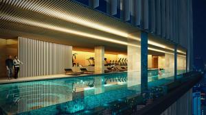 a large swimming pool in a building with a city at Mercure Bangkok Siam Ratchathewi in Bangkok