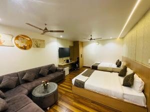 a hotel room with a bed and a couch at Hotel JK palace in Allahābād