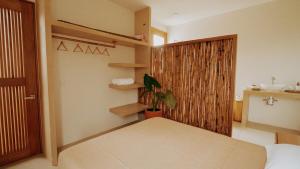 a bedroom with a bed and a closet with shelves at Aguamiel Agua Blanca in Playa Agua Blanca