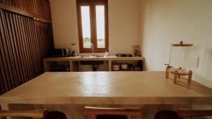 a kitchen with a large wooden table and a sink at Aguamiel Agua Blanca in Playa Agua Blanca +5 photos
