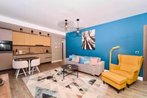 a living room with a couch and a table at Mariah Spa Deluxe Adults Only in Poiana Brasov