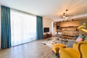 a living room with a couch and a table at Mariah Spa Deluxe Adults Only in Poiana Brasov