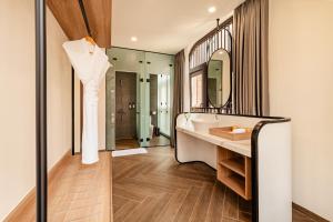 a bathroom with a white dress hanging on a wall at Lumiere Boutique Vỹ Dạ in Thôn Lại Thê +65 photos
