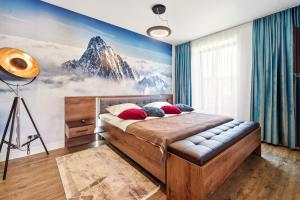 a bedroom with a mountain mural on the wall at Mariah Spa Deluxe Adults Only in Poiana Brasov +47 photos