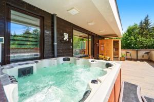a hot tub in the middle of a house at Mariah Spa Deluxe Adults Only in Poiana Brasov