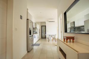 a kitchen with white walls and a long hallway at Ebene City Centre - 2 Bedroom Apartment in Ebene